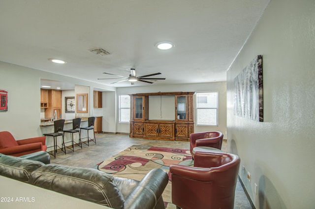 living room with ceiling fan and a healthy amount of sunlight