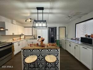 404 E Forest Dr, Payson, AZ 85541 - kitchen featuring stainless steel electric stove, fridge with ice dispenser, white cabinetry, and a ceiling fan