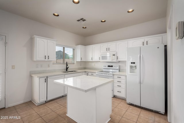 kitchen featuring a sink, white appliances, white cabinetry, light tile patterned floors, and visible vents