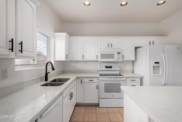 kitchen featuring a sink, recessed lighting, white cabinets, and white appliances