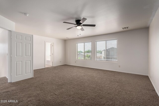 empty room with carpet floors, ceiling fan, and baseboards