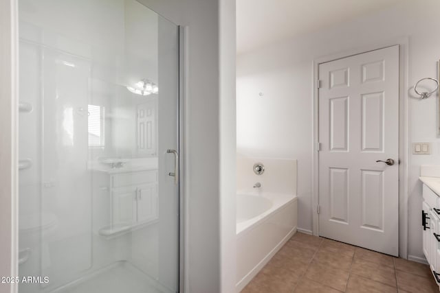 bathroom with vanity, tile patterned floors, a bath, and a shower stall