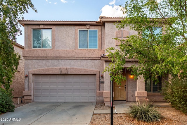 traditional-style house with concrete driveway, stucco siding, and a garage