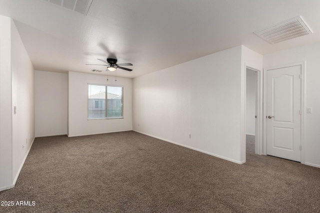 spare room featuring carpet flooring, ceiling fan, and visible vents