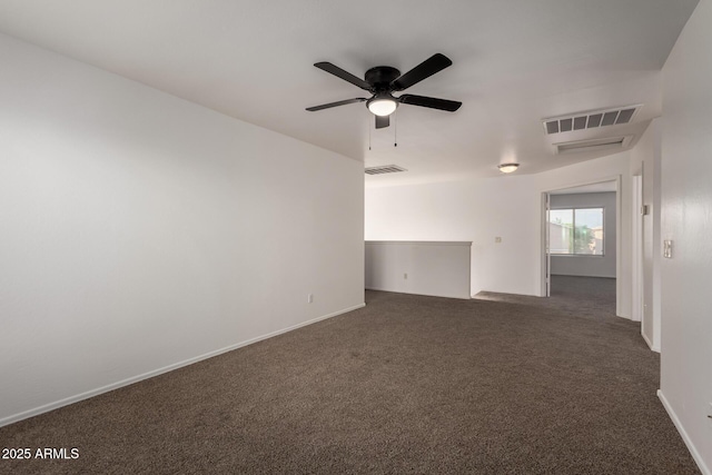 unfurnished room featuring ceiling fan, dark colored carpet, and visible vents