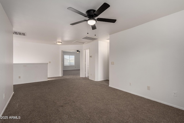 carpeted spare room with ceiling fan, visible vents, and baseboards
