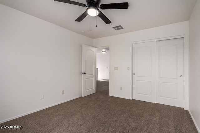 unfurnished bedroom featuring visible vents, a closet, baseboards, a ceiling fan, and carpet