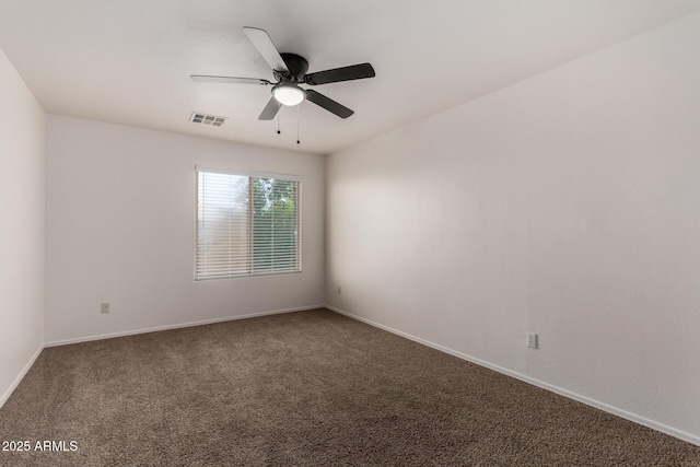 unfurnished room with baseboards, ceiling fan, carpet flooring, and visible vents