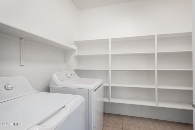 laundry room featuring washer and dryer, laundry area, and light tile patterned floors
