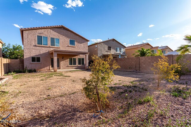 back of house with a patio, a fenced backyard, and stucco siding