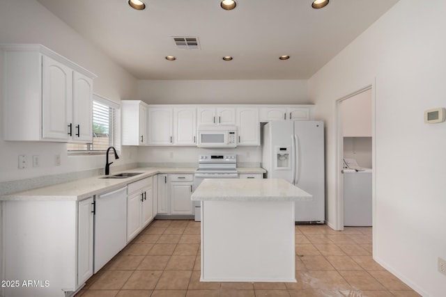 kitchen with a sink, white appliances, a center island, white cabinetry, and visible vents