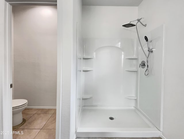35337 W San Alvarez Ave, Maricopa, AZ 85138 - bathroom with a stall shower, toilet, and tile patterned floors