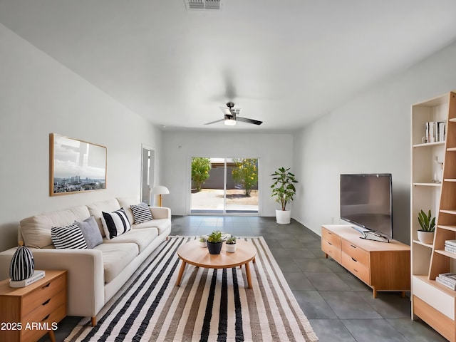 35337 W San Alvarez Ave, Maricopa, AZ 85138 - living area with dark tile patterned floors and a ceiling fan