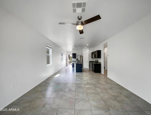 35337 W San Alvarez Ave, Maricopa, AZ 85138 - unfurnished living room with a ceiling fan, light tile patterned floors, baseboards, and recessed lighting