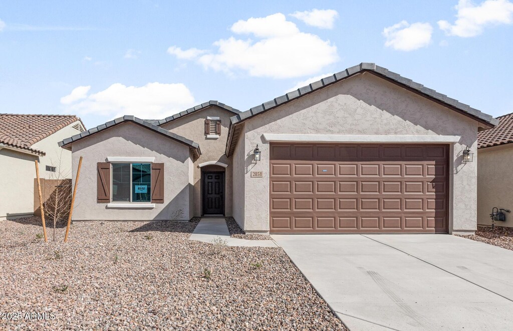 2851 N Coronado Dr, Florence, AZ 85132 - view of front facade featuring a garage, a tile roof, driveway, and stucco siding