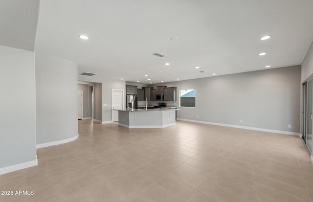 2851 N Coronado Dr, Florence, AZ 85132 - unfurnished living room featuring recessed lighting, visible vents, and baseboards