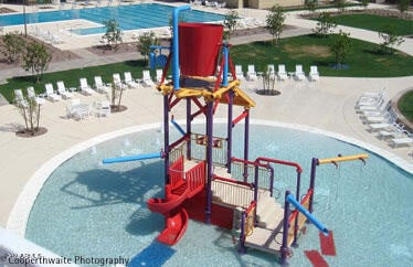 view of jungle gym with a patio area and a community pool