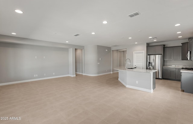 2851 N Coronado Dr, Florence, AZ 85132 - kitchen with visible vents, gray cabinetry, appliances with stainless steel finishes, open floor plan, and a sink