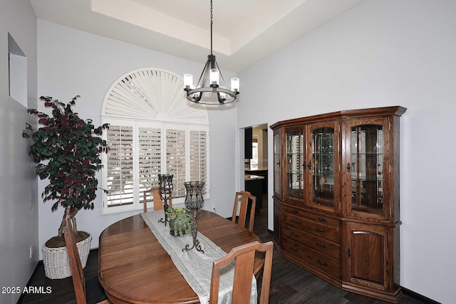 dining space with a chandelier and dark wood finished floors
