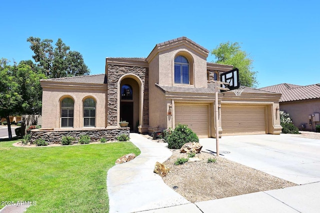 mediterranean / spanish home with stucco siding, a front lawn, concrete driveway, a tile roof, and stone siding
