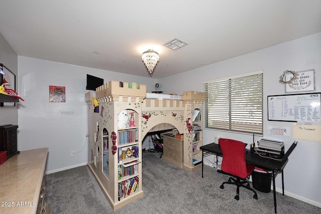 carpeted bedroom with an office area and baseboards