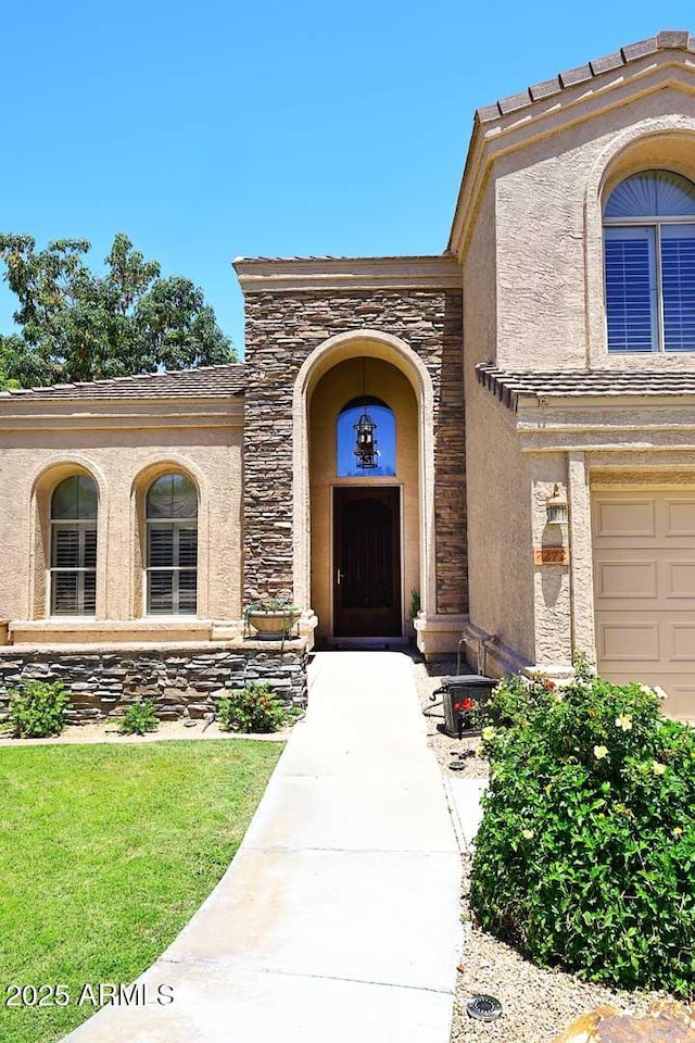 property entrance featuring stone siding and stucco siding