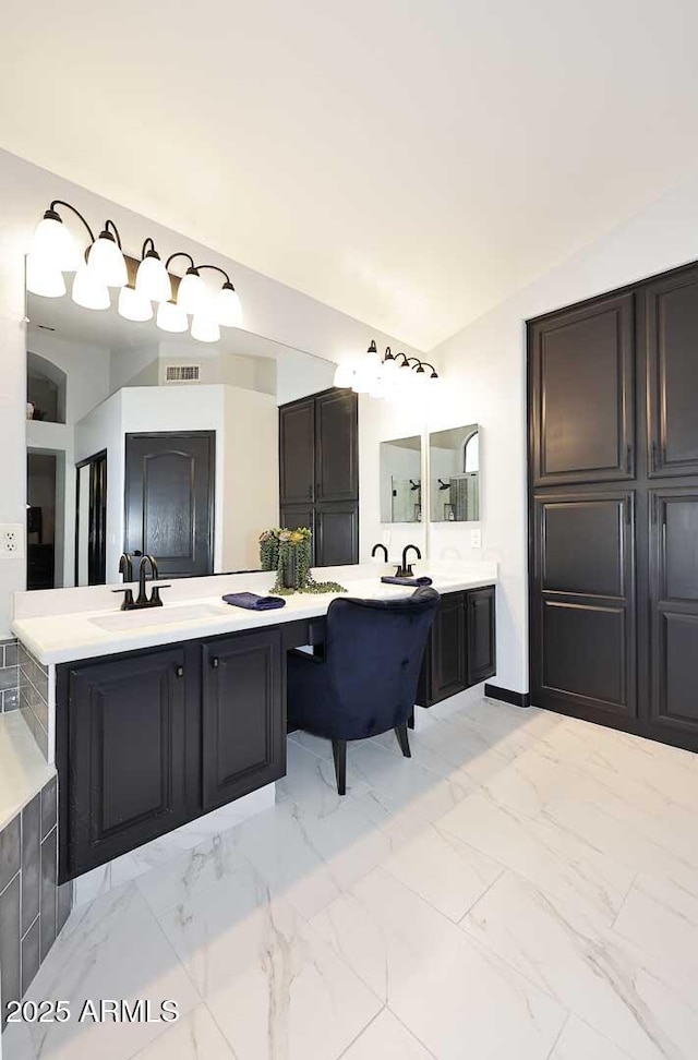 full bath featuring marble finish flooring, lofted ceiling, and vanity