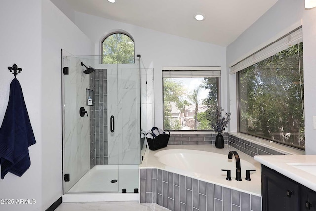 full bathroom with vaulted ceiling, a stall shower, a garden tub, vanity, and recessed lighting