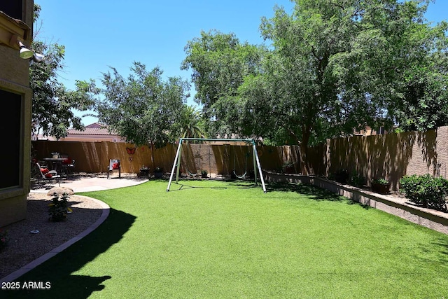 view of yard featuring a playground and a patio
