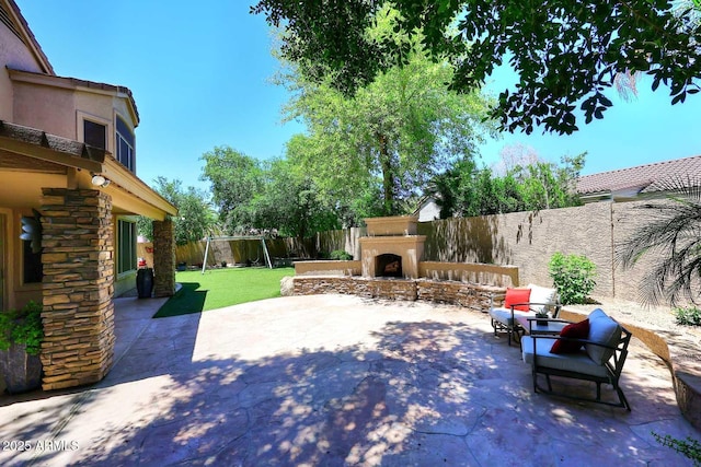 view of patio with an outdoor fireplace