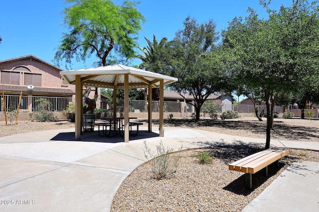 view of property's community featuring a gazebo, fence, and a patio