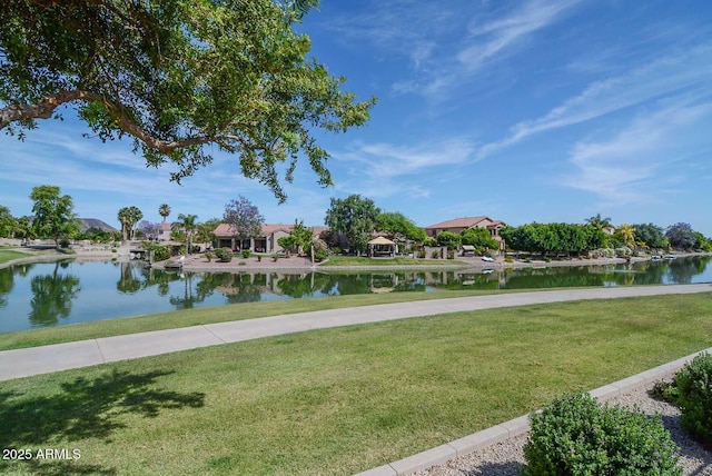 surrounding community with a water view, a yard, and a residential view
