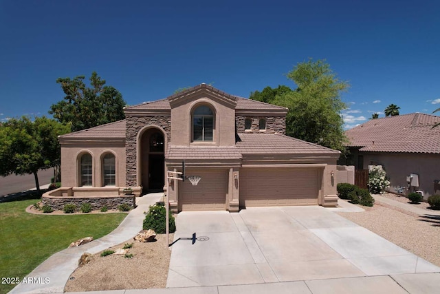 mediterranean / spanish-style house featuring a tile roof, stucco siding, concrete driveway, an attached garage, and a front lawn
