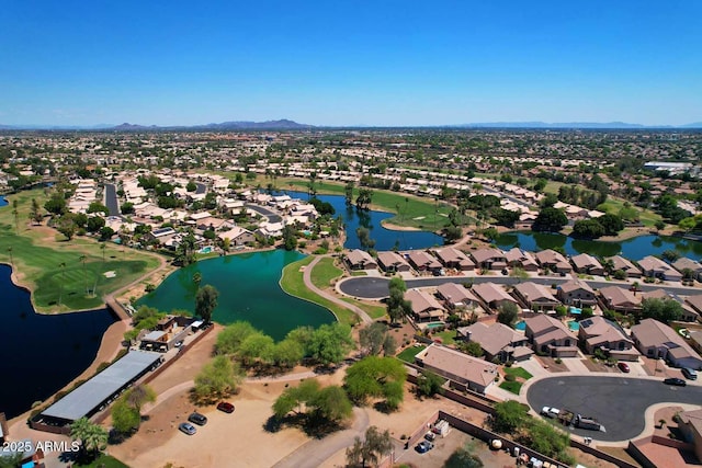 aerial view of property's location with nearby suburban area and a water and mountain view