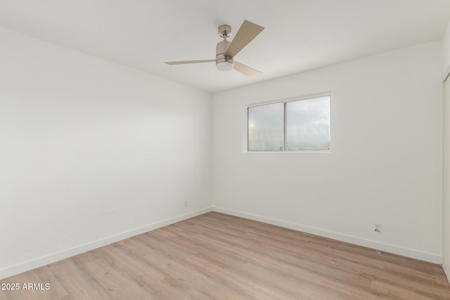 empty room with light wood-type flooring, baseboards, and a ceiling fan