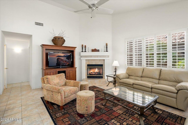 tiled living room featuring a high ceiling and ceiling fan