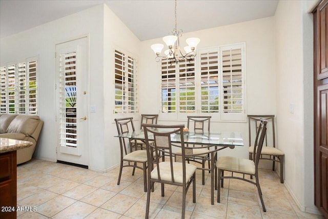 tiled dining space with an inviting chandelier