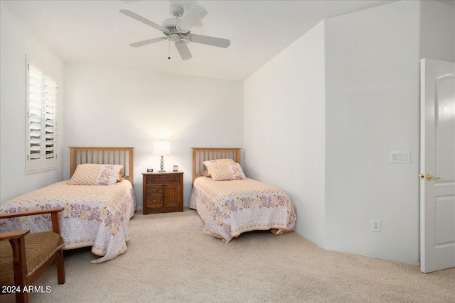 bedroom with light carpet and ceiling fan