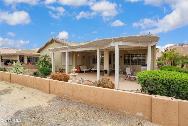 back of property with a patio and ceiling fan