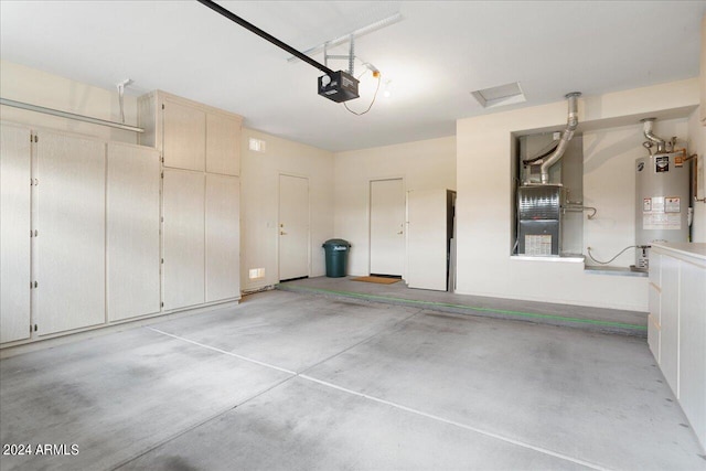 garage featuring heating unit, water heater, and a garage door opener