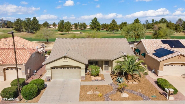 view of front of home with a garage and solar panels