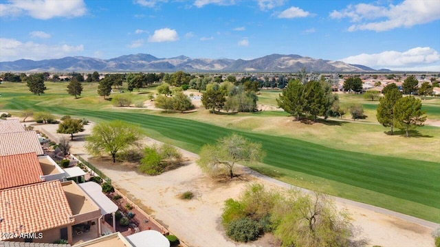 exterior space featuring a mountain view and a lawn