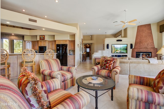 living room with light tile patterned flooring, a fireplace, and ceiling fan