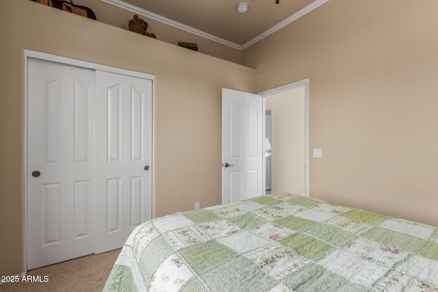 carpeted bedroom featuring crown molding and a closet
