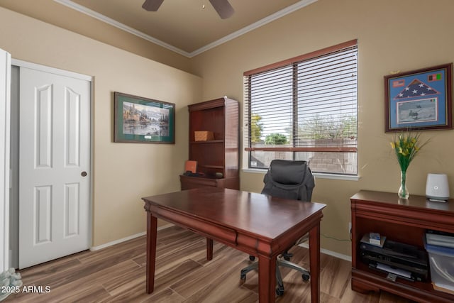 office space featuring crown molding, baseboards, a ceiling fan, and wood finished floors