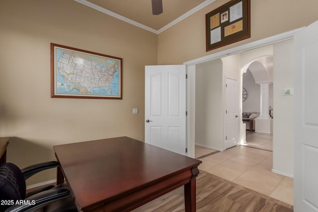 office area featuring ceiling fan, arched walkways, baseboards, ornamental molding, and ornate columns