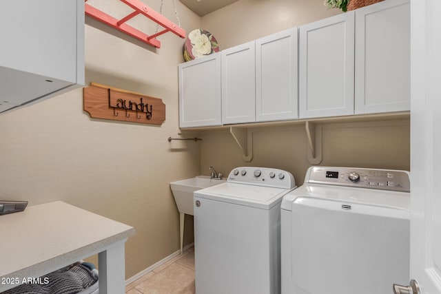 laundry room with cabinet space, independent washer and dryer, a sink, and light tile patterned floors