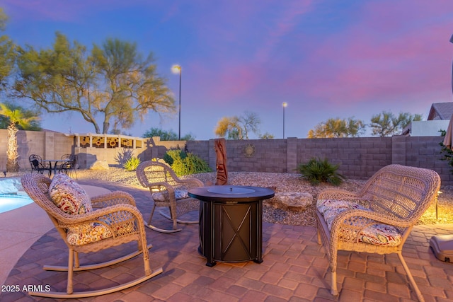 view of patio / terrace featuring a fenced backyard and an outdoor fire pit