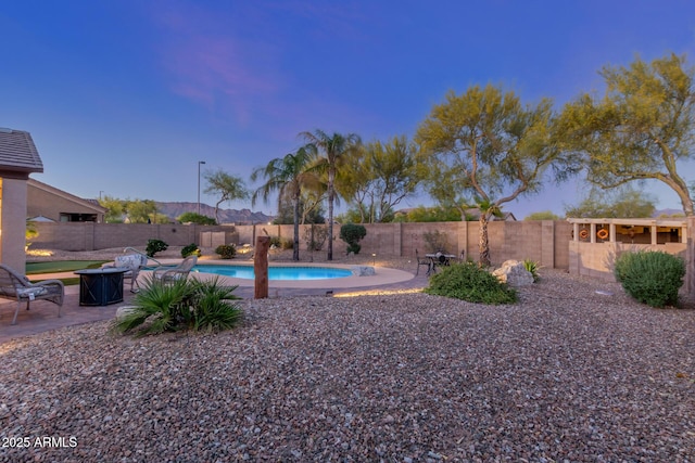view of yard with a fenced in pool, a fenced backyard, and a patio area