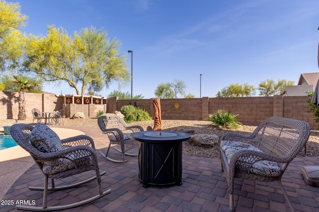 view of patio / terrace featuring a fire pit and a fenced backyard